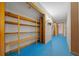 Hallway with blue flooring and wooden shelving at 4301 Se 38Th St, Ocala, FL 34480