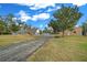 House with long driveway, detached garage, and trees at 4301 Se 38Th St, Ocala, FL 34480