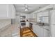 Bright kitchen features white cabinets, stainless steel appliances, and granite countertops at 4301 Se 38Th St, Ocala, FL 34480