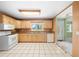 Bright kitchen features wood cabinets, granite countertops, and white appliances at 4301 Se 38Th St, Ocala, FL 34480