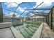 Enclosed pool with green water needing cleaning at 4301 Se 38Th St, Ocala, FL 34480