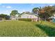View of the home's side showcasing a large yard at 438 Spring Ln, Ocala, FL 34472