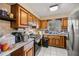 Galley kitchen with wood cabinets and appliances at 438 Spring Ln, Ocala, FL 34472