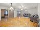 Spacious living room with hardwood floors and glass sliders leading to a sunroom at 438 Spring Ln, Ocala, FL 34472