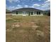 Back exterior featuring a large backyard and green exterior at 6414 Sw 67Th Pl, Ocala, FL 34476