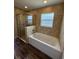 Bathroom featuring a bathtub with shower and tile surround at 6414 Sw 67Th Pl, Ocala, FL 34476