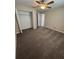 Bedroom featuring neutral walls, plush carpet, ceiling fan, and a closet at 6414 Sw 67Th Pl, Ocala, FL 34476