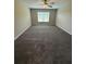 Empty bedroom with neutral walls, carpet, a ceiling fan, and a window at 6414 Sw 67Th Pl, Ocala, FL 34476