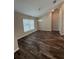 Bright dining room featuring hardwood floors, a chandelier, and large windows allowing ample natural light at 6414 Sw 67Th Pl, Ocala, FL 34476