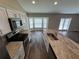 Bright kitchen featuring stainless steel appliances, marble countertops, and natural light from a bay window at 6414 Sw 67Th Pl, Ocala, FL 34476