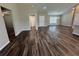 Spacious living area with vinyl flooring, neutral paint, and an open layout to other rooms of the house at 6414 Sw 67Th Pl, Ocala, FL 34476