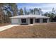 Newly constructed single-story home with a landscaped yard at 67 Nw Sparrow Rd, Dunnellon, FL 34431