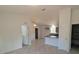 Open kitchen with grey cabinets, tile floors, and island at 67 Nw Sparrow Rd, Dunnellon, FL 34431