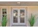 White double French doors with decorative glass panes at 6858 Sw 111Th Loop, Ocala, FL 34476