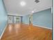 Bright living room featuring wood floors, a ceiling fan, and a front door at 8655 Sw 98Th Street Rd # G, Ocala, FL 34481