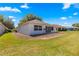 Lawn view of home with patio and screened windows at 9014 Sw 96Th Ter, Ocala, FL 34481