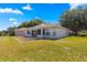 Exterior view of home's screened lanai and backyard at 9014 Sw 96Th Ter, Ocala, FL 34481