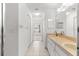 Bathroom featuring double sinks, shower and a large mirror at 9014 Sw 96Th Ter, Ocala, FL 34481