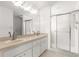 Bathroom featuring double sinks, shower and a large mirror at 9014 Sw 96Th Ter, Ocala, FL 34481