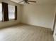 Spacious bedroom featuring new laminate flooring, ceiling fan and two bright windows at 9014 Sw 96Th Ter, Ocala, FL 34481