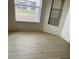 Bright bedroom featuring new laminate flooring and two bright windows at 9014 Sw 96Th Ter, Ocala, FL 34481