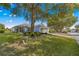 Single-story home with a landscaped yard and attached garage, set back from the street at 9014 Sw 96Th Ter, Ocala, FL 34481
