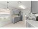 Bright kitchen with stainless steel appliances, gray cabinets, and tile flooring at 9014 Sw 96Th Ter, Ocala, FL 34481