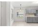 Sunlit kitchen nook with tile flooring, gray cabinets and natural light at 9014 Sw 96Th Ter, Ocala, FL 34481