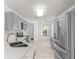 Bright kitchen with stainless steel appliances, gray cabinets, and tile flooring at 9014 Sw 96Th Ter, Ocala, FL 34481