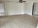 Spacious living room with updated lighting fixtures and light wood laminate flooring at 9014 Sw 96Th Ter, Ocala, FL 34481