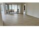 Bright living room with sliding glass doors to screened porch and light wood flooring at 9014 Sw 96Th Ter, Ocala, FL 34481
