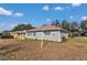 Well-maintained backyard and side view of the house exterior displaying manicured flowerbeds and a green lawn at 9708 Sw 97Th St, Ocala, FL 34481