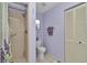 Well-lit bathroom featuring a shower, toilet, and storage at 9708 Sw 97Th St, Ocala, FL 34481