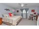 Spacious bedroom features a rocking chair and plenty of natural light at 9708 Sw 97Th St, Ocala, FL 34481