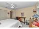 Bedroom featuring a ceiling fan, closet, desk area, and cozy seating for relaxation at 9708 Sw 97Th St, Ocala, FL 34481