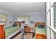 Cozy bedroom featuring twin beds, wood floors, and natural light from windows at 9708 Sw 97Th St, Ocala, FL 34481