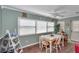 Bright breakfast nook with a white table and chairs, with natural light from windows at 9708 Sw 97Th St, Ocala, FL 34481