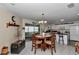 Charming dining area with a round table, chairs, and adjacent kitchen featuring white cabinets at 9708 Sw 97Th St, Ocala, FL 34481