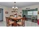 Cozy dining area featuring a round table and chairs, with decor and bright light from adjacent windows at 9708 Sw 97Th St, Ocala, FL 34481