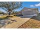 Charming home featuring a well-maintained lawn, long driveway, covered porch, and an attached garage at 9708 Sw 97Th St, Ocala, FL 34481