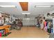 Spacious garage with an open door, golf cart, bicycles and overhead lighting at 9708 Sw 97Th St, Ocala, FL 34481