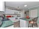 Functional kitchen featuring white cabinets, green counters and modern appliances at 9708 Sw 97Th St, Ocala, FL 34481