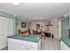 Spacious kitchen that connects to a dining area, featuring white cabinets and green countertops at 9708 Sw 97Th St, Ocala, FL 34481