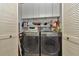 Convenient laundry area with modern washer and dryer units and ample storage shelves at 9708 Sw 97Th St, Ocala, FL 34481