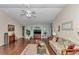 Bright living room featuring a ceiling fan, hardwood floors, and a decorative sofa at 9708 Sw 97Th St, Ocala, FL 34481