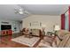 Spacious living room featuring hardwood floors, ceiling fan, and comfortable seating at 9708 Sw 97Th St, Ocala, FL 34481