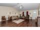 Bright living room featuring hardwood floors, a ceiling fan, comfortable seating, and natural light at 9708 Sw 97Th St, Ocala, FL 34481