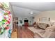 Open-concept living room featuring hardwood floors, a ceiling fan, and neutral paint at 9708 Sw 97Th St, Ocala, FL 34481