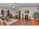 Open-concept living room featuring hardwood floors, comfortable seating, and neutral paint at 9708 Sw 97Th St, Ocala, FL 34481