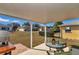 Outdoor patio with a brick extension, outdoor table, grill and expansive backyard with neighboring homes at 9708 Sw 97Th St, Ocala, FL 34481